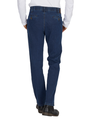 Frontansicht einer Person in einer jeansblauen GARVEY 6822 Flat Front-Hose mit elastischem Komfortbund, Bundverlängerung, Thermolite-Wärmeisolierung, Regular Fit und schmaler Fußweite, hergestellt aus High Stretch-Denim; die Person trägt schwarze Schuhe und ein weißes Hemd.